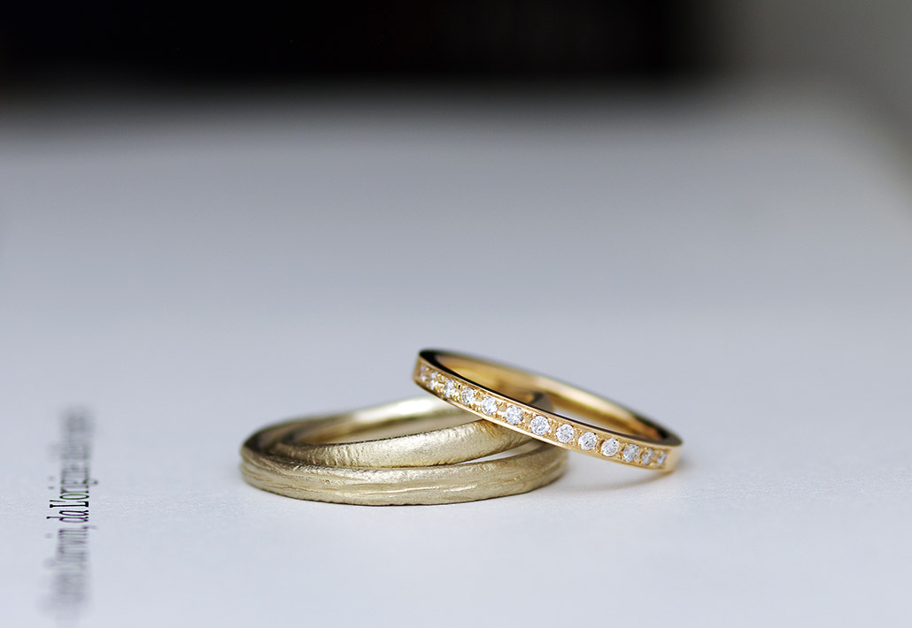 ぼこぼこ、ざらざらとした質感が特徴の結婚指輪とエタニティデザインの婚約指輪